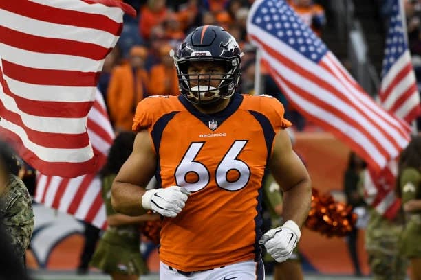 Jared Veldheer in his number 66 Denver Broncos uniform, with American flags in the background.